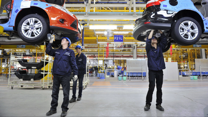 Employees install car components at an assembly line at a Ford manufacturing plant in Chongqing municipality, April 20, 2012. The new Ford car massive manufacturing plant, which opened in February, will need to be a success if Ford is to get a better foothold in the world's biggest car market, where it badly lags rivals such as General Motors Co and Volkswagen AG, which together produced the six top-selling cars in the country in 2011. Ford -- which was late getting into China -- had just 2.8 percent of the 18.5 million vehicle market last year, against GM's 14 percent and VW's 12 percent. Picture taken April 20, 2012. To match FEATURE FORD-CHINA/ REUTERS/Stringer