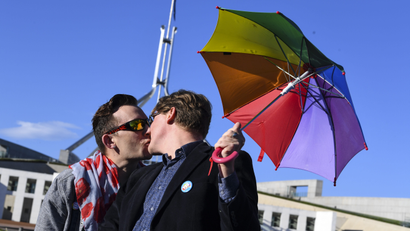 A couple kisses outside Parliament House during an equality rally in Canberra, Australian Capital Territory, Australia, 07 December 2017. A bill allowing same-sex couples to marry could see its historic pass on the day as the Australian parliament is on its final sitting. EPA-EFE/LUKAS COCH AUSTRALIA AND NEW ZEALAND OUT