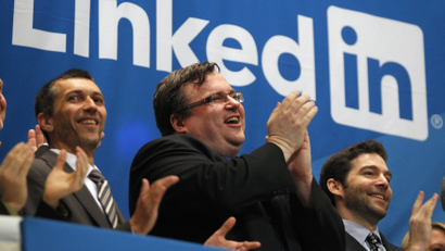 Linkedin founder and CEO applaud from bell balcony of New York Stock Exchange after opening bell during IPO