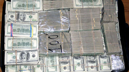A haul of about 206 million U.S. dollars is seen after it was found stashed in closets, suitcases, and drawers in a house in an upscale neighbourhood of Mexico City March 15, 2007. law enforcement officials said the money belonged to drugs smugglers who imported chemicals used to make methamphetamines. Seven people were arrested in the raid. Picture taken March 15, 2007. QUALITY FROM SOURCE