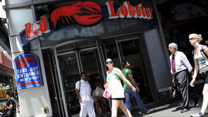 Passersby walk in front of the Times Square Red Lobster restaurant in New York, June 23, 2010. Darden Restaurants, the owner of Red Lobster and other chains such as Olive Garden, is trading higher ahead of it's quarterly earnings report. REUTERS/Keith Bedford