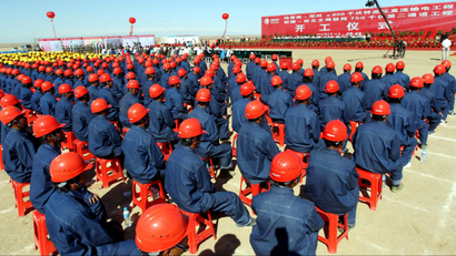 Chinese workers from the State Grid Corporation of China attend the groundbreaking ceremony for a converter station of the 800 kilovolt (kv) ultra-high voltage power line project in Hami prefecture, northwest Chinas Xinjiang province, 13 May 2012. China took a major step towards upgrading its energy infrastructure by announcing the construction of the worlds largest transmission line, a massive 800 kilovolt (kv) ultra-high voltage power line that is capable of transmitting a whopping 37 billion kWh per year. Built by the State Grid Corporation of China, the high-capacity power line will stretch 1,373 miles from Hami prefecture in northwest Chinas Xinjiang region through Gansu, Shaanxi, Ningxia and Shanxi before finishing in Zhengzhou, the capital of central Chinese province of Henan. The power line costs 23.39 billion yuan (US$3.7 bn). Once it is completed in 2014, it will have a world record capacity of eight million kW.(Imaginechina via AP Images