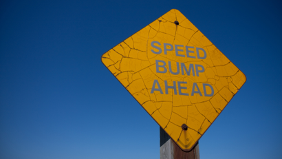 A sign reading "Speed Bump Ahead"