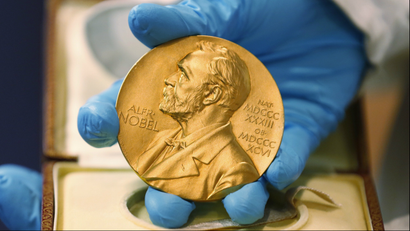 LE- In this file photo dated Friday, April 17, 2015, A national libray employee shows the gold Nobel Prize medal awarded to the late novelist Gabriel Garcia Marquez, in Bogota, Colombia. The beginning of October 2015 means Nobel Prize time, when committees in Stockholm and Oslo announce the winners of what many consider the most prestigious awards in the world, each worth some 8 million Swedish kronor (US dlrs 960,000) presented to the worthy recipients with a diploma and a gold medal. (AP Photo/Fernando Vergara