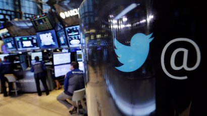 The Twitter logo appears on a phone post on the floor of the New York Stock Exchange, Tuesday, Oct. 13, 2015. Twitter is laying off up to 336 employees, signaling CEO Jack Dorsey's resolve to slash costs while the company struggles to make money. (AP Photo/Richard Drew)