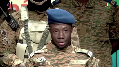 A soldier of the Burkina Faso military on a television screen after a coup that toppled the country's president