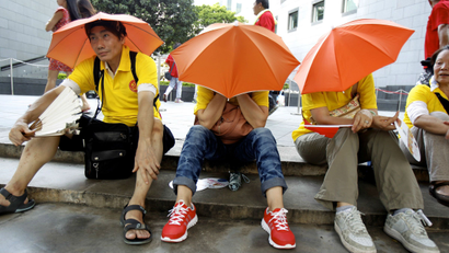 Pro-Beijing protesters rest after taking part in a march to demonstrate against a pro-democracy Occupy Central campaign in Hong Kong August 17, 2014.
