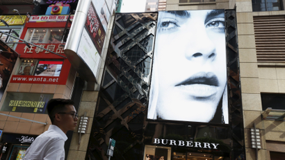A model is seen on the screen of a Burberry store at Causeway Bay shopping district in Hong Kong, China, July 16, 2015. British luxury goods maker Burberry says its Hong Kong comparable store sales fell by a double-digit percentage in the quarter ending June 30, becoming the latest brand to show business is hurting.