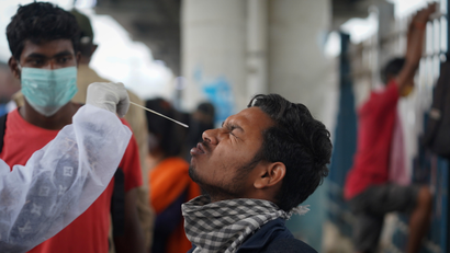 A health worker collects a swab sample from a man during a rapid antigen testing campaign for the coronavirus disease (COVID-19) in Mumbai
