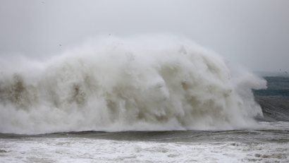 A big wave breaking on a shoreline
