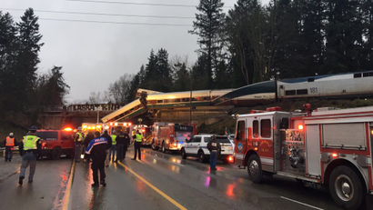 First responders are seen at the scene of an Amtrak passenger train derailment on interstate highway (I-5) in this Washington State Patrol image moved on social media in DuPont, Washington, U.S.