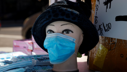A mannequin is seen displayed with a surgical mask where a vendor was selling packages of surgical masks on a street corner in the Chelsea neighborhood of Manhattan