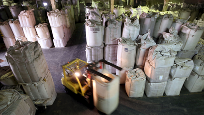 A worker transports 1-tonne super sacks with coffee beans for export at a coffee warehouse in Santos, Brazil.