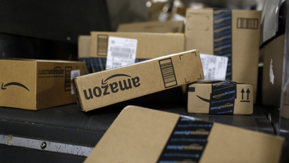 In this Nov. 20, 2015, photo, packages being shipped in Amazon boxes ride a conveyor belt at the UPS Worldport hub in Louisville, Ky.