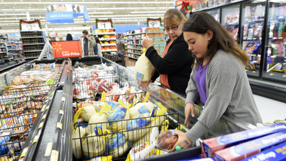 Mother and daughter shop for turkey at a Walmart.