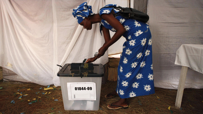 A voter casts her ballot during Rwanda's presidential election.