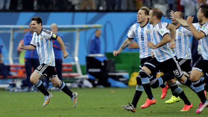 Argentina's Lionel Messi, left, reacts with his teammates after Maxi Rodriguez scored the winning goal during a penalty shootout after extra time during the World Cup semifinal soccer match between the Netherlands and Argentina at the Itaquerao Stadium in Sao Paulo Brazil, Wednesday, July 9, 2014. Argentina defeated the Netherlands 4-2 in a penalty shootout after a 0-0 tie to advance to the finals. (AP Photo/Victor R. Caivano)
