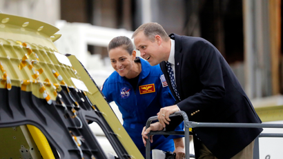 NASA Administrator James Bridenstine, right, and astronaut Nicole Mann look at the Orion Exploration Mission 2 crew capsule, the first one that will fly into space with a crew, at the NASA Michoud Assembly Facility in New Orleans, Monday, Aug. 13, 2018.