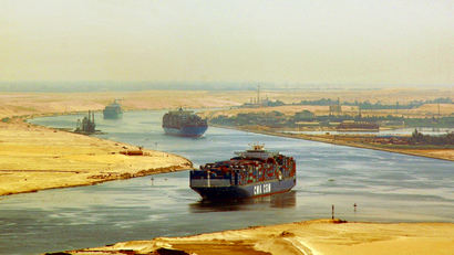 In this photo taken Monday, Sept. 21, 2009, cargo ships sail through the Suez Canal, seen from a helicopter, near Ismailia, in Egypt.