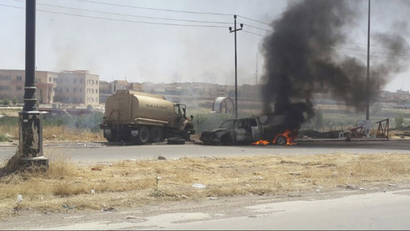 Burning vehicles belonging to Iraqi security forces in Mosul.