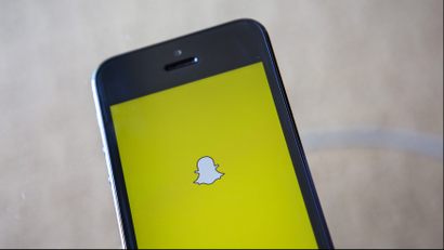 A portrait of the Snapchat logo on a mobile phone.