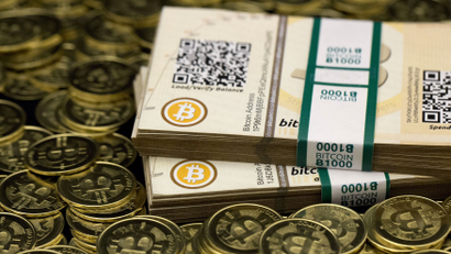 Some of Bitcoin enthusiast Mike Caldwell's coins and paper vouchers often called "paper wallets" are pictured at his office in Sandy, Utah