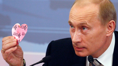 Russia's President Vladimir Putin holds up a heart.