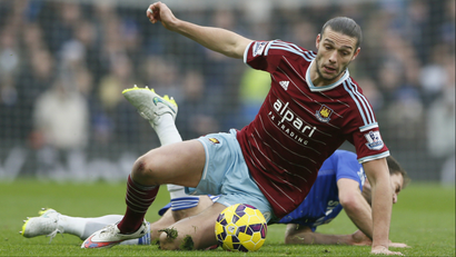 Chelsea's Branislav Ivanovic is challenged by West Ham United's Andy Carroll during their English Premier League soccer match at Stamford Bridge in London, December 26, 2014.