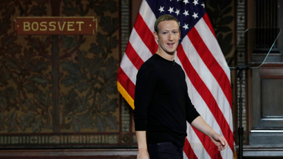 Mark Zuckerberg in front of an American flag