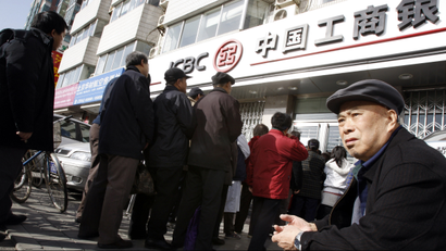 Local residents wait outside a branch of the Industrial and Commercial Bank of China (ICBC), in Beijing, China, Monday, March 16, 2009. People began waiting in the early hours of the morning for a new issue of government bonds being released by the bank at 9.00am. The release of the government bonds was the first of the year. (AP Photo/Greg Baker