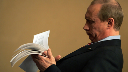 Russian President Vladimir Putin checks his notes.