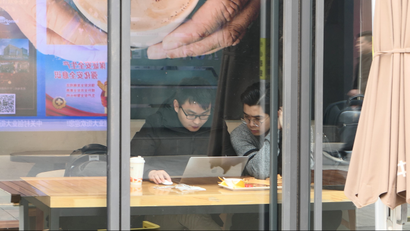 Men use a laptop inside a coffee shop in Beijing's tech hub Zhongguancun, China February 22, 2019. Picture taken February 22, 2019. REUTERS/Stringer ATTENTION EDITORS - THIS IMAGE WAS PROVIDED BY A THIRD PARTY. CHINA OUT.