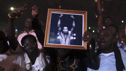 People hold up a photo of Nigeria's music legend Fela Kuti at a night show marking the end of a week-long celebration in his honour, in Lagos October 22, 2012