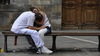 A sleeping couple embrace on the fifth day of the San Fermin festival in Pamplona, Italy.