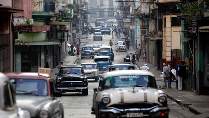 Classic American cars used as collective taxis drive along a street in Havana, Cuba, Friday, Jan. 16, 2015. Tens of thousands more American tourists are expected to flock this year to a country where some five-star hotels don't have working air-conditioning or hand towels. The Obama administration hopes the new wave of U.S. tourists will fuel one of the healthiest parts of Cuba's new entrepreneurial sector, the thousands of private bed and breakfasts.
