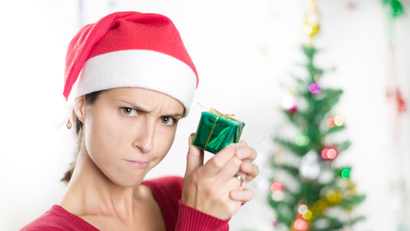 Disappointed woman with small wrapped gift
