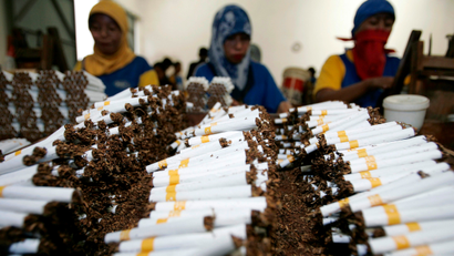Workers roll cigarettes in a factory in Sidoarjo, East Java province February 2, 2009. The company's production manager said on Monday that the production of cigarettes has decreased after Indonesia's Ulema Council (MUI) issued a fatwa prohibiting smoking in public places and by pregnant women and children. Indonesian smokers and the country's tobacco industry have slammed a move by the nation's top Islamic body to place restrictions on tobacco use by Muslims, calling it an interference in private lives. Health campaigners welcomed the move, but said the government now needed to do more if there was to be any impact on curbing smoking in the world's fifth largest tobacco market.