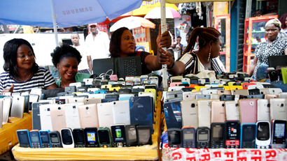 Women vendors display Nokia phone models for sale along with smartphones at the 'Computer Village' in Ikeja district in Nigeria's commercial capital Lagos.