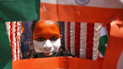 A fan with her face painted with the colours of India's national flag attends a special prayer ceremony for the victory of the Indian cricket team before the start of the ICC Cricket World Cup semi-final match between India and Pakistan, in the southern Indian city of Hyderabad March 30, 2011. The prime ministers of India and Pakistan will mix with Bollywood stars and thousands of fans as the two rivals square off in a World Cup cricket semi-final on Wednesday in the wake of high profile peace talks between the two nations. The two teams will meet in Mohali with army helicopters and anti-aircraft guns imposing a no-fly zone over the stadium a few hours' drive east of the Pakistan border. REUTERS/Krishnendu Halder (INDIA - Tags: SPORT CRICKET SOCIETY)
