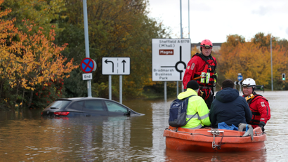 Firefighters and first responders rescue rescue people stranded in a flooded road in central Rotherham, near Sheffield