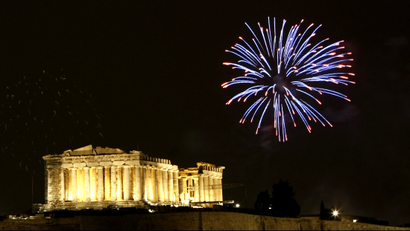 Fireworks explode over the temple of the Parthenon atop the hill of the Acropolis.