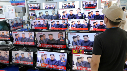 A man watches TV news report about North Korea's nuclear test at an electronic shop in Seoul, South Korea