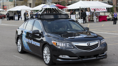 An Acura RLX sedan, a prototype car, is shown during a demonstration in Detroit, Tuesday, Sept. 9, 2014.