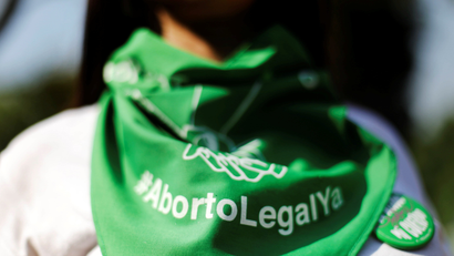 A green bandana reads, Aborto Legal