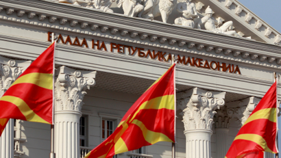 National Macedonian flags flutter in front of the government building in Skopje, Macedonia.