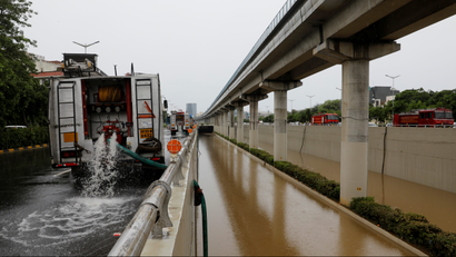 A fire truck pumps out water from a flooded underpass after heavy rains in Gurugram, India, August 20, 2020.