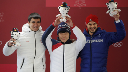 At the Pyeongchang 2018 Winter Olympics, men's skeleton gold medallist Yun Sung-bin of South Korea, silver medallist Nikita Tregubov, and bronze medallist Dom Parsons of Britain pose at the victory ceremony.