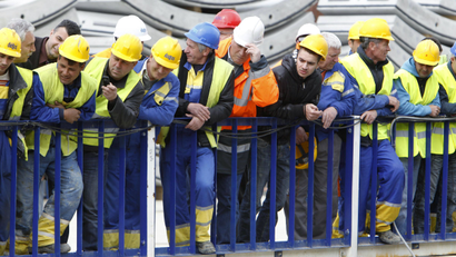 Workers look at the new drilling machine at a construction site of Sofia's metropolitan.