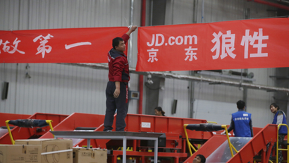 An employee works at a JD.com logistic centre in Langfang, Hebei province, November 10, 2015. On China's giant Singles Day internet shopping festival, the country's delivery firms are stretched so thin that they are looking for tie-ups, listings and new investors to husband their resources. E-commerce has been a huge boon to the logistics industry, but the ever-bigger Singles Day, run by leading online market company Alibaba Group Holding Ltd on Nov. 11 every year, exacerbates the industry's twin dilemmas of cut-throat competition and rising labor costs. With low barriers to entry, express couriers proliferated rapidly over the past decade to more than 8,000 firms, squeezing profit margins to about 5 percent, down from 30 percent 10 years ago, according to analysts.