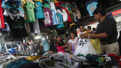 People shop for clothes at a roadside market in Kolkata